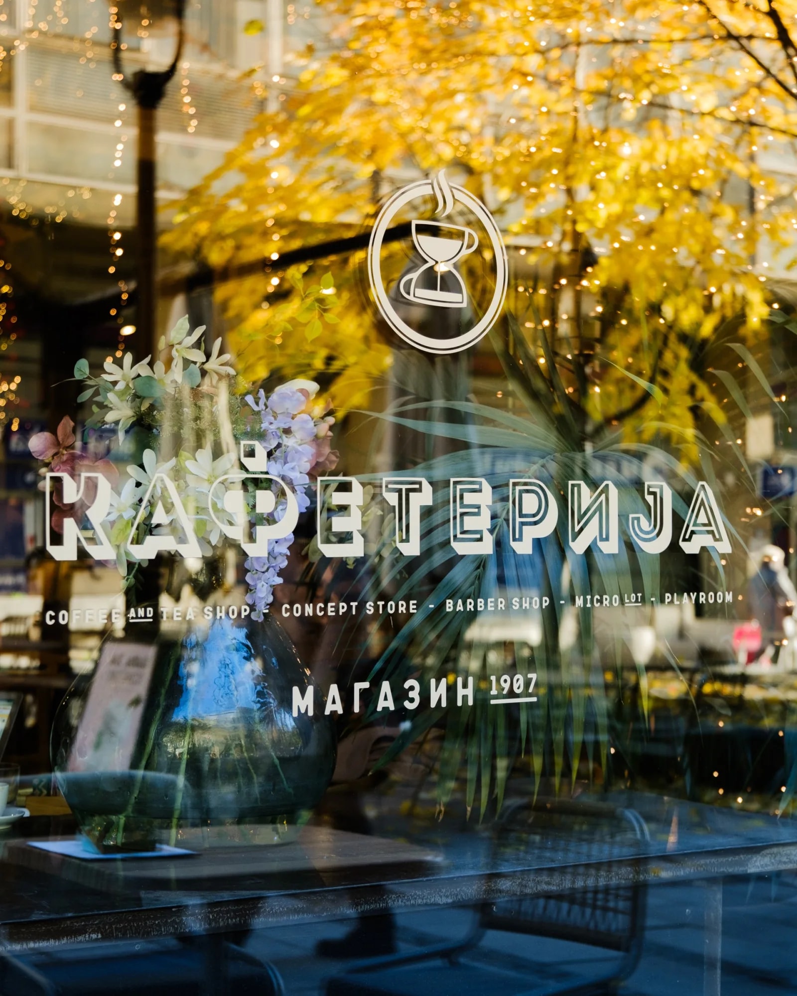 The window of a Kafeterija café, with the logo and lettering painted on the glass