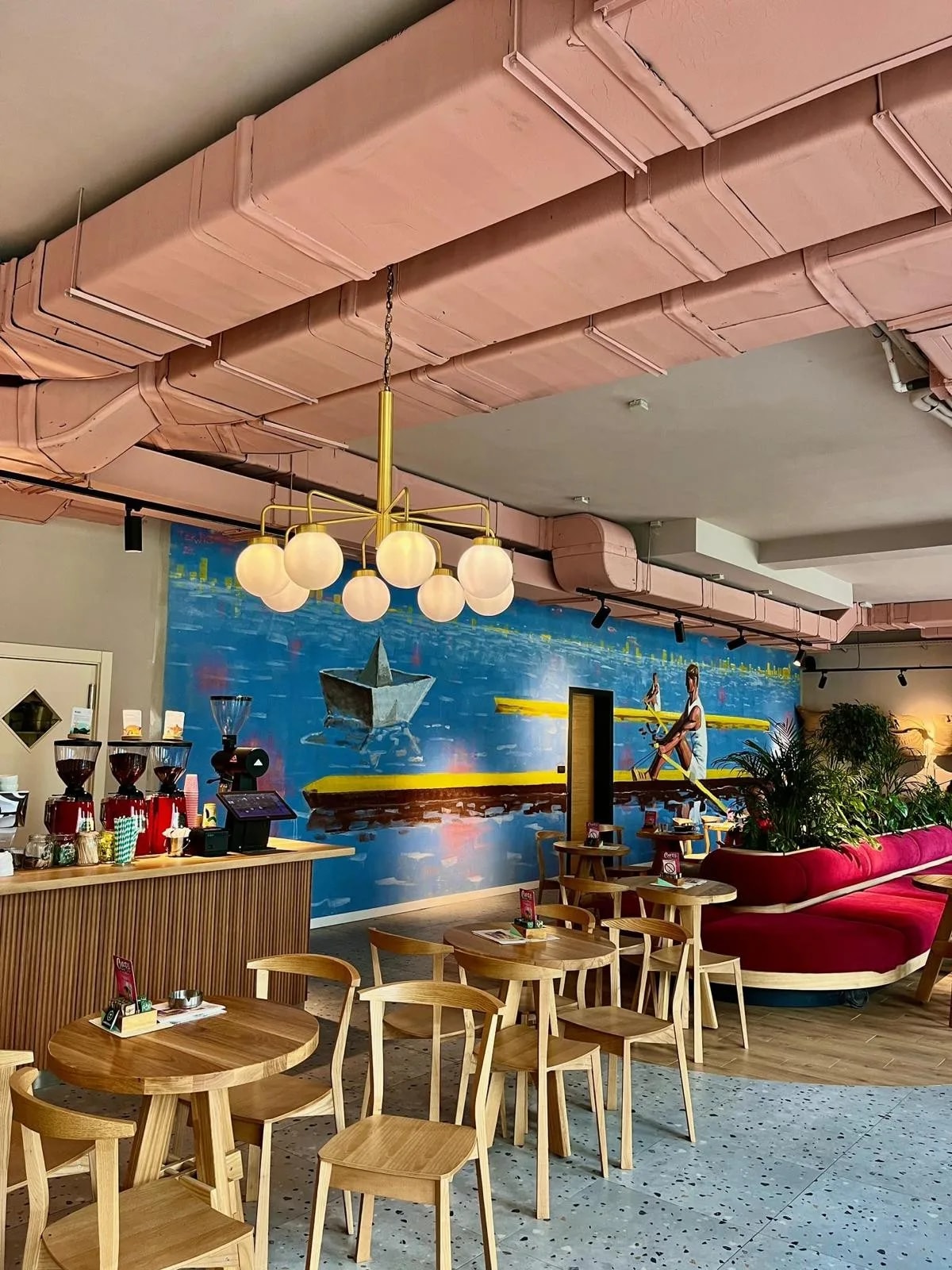 Dining area with a mural at a Kafeterija café